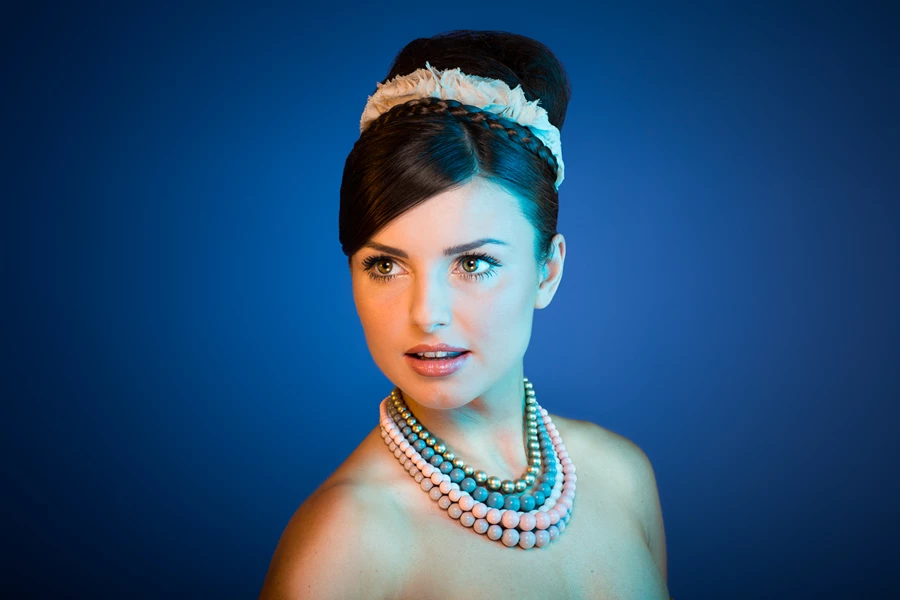 Studio beauty photo of woman against blue background