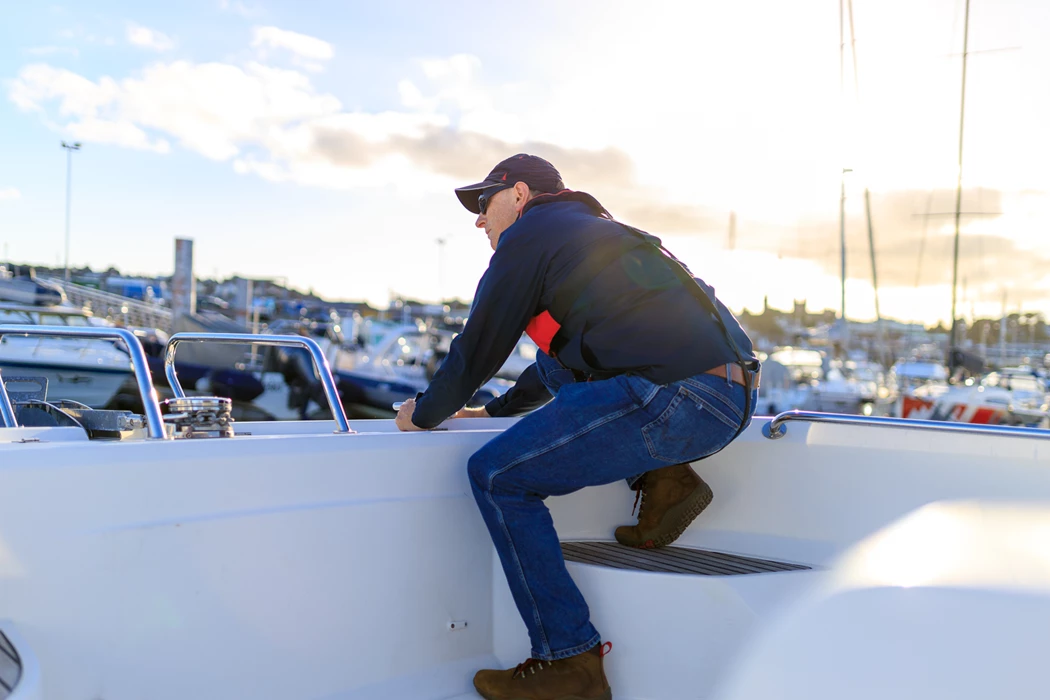 Colour photo of a person jumping on a roof