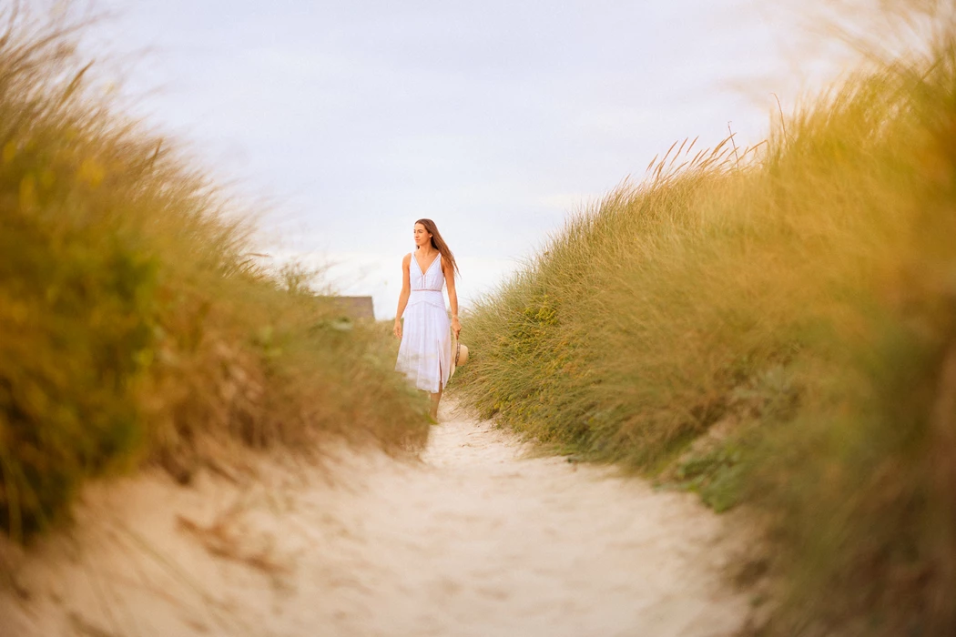 Colour photo of a person walking on a dirt path