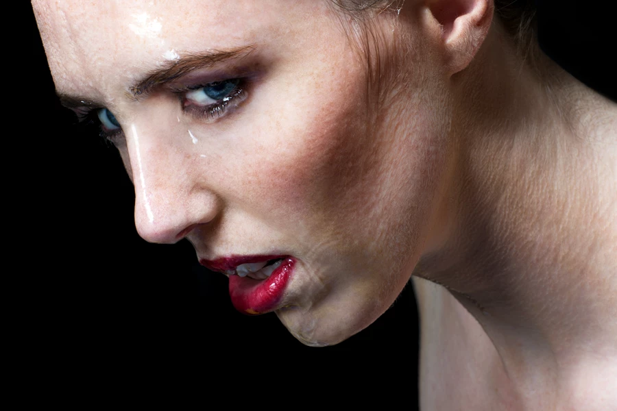 Studio beauty photo of woman with water running down face