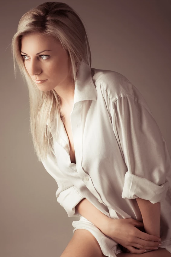 Studio fashion photo of woman in white shirt