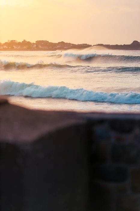 Colour photo of waves crashing on a beach